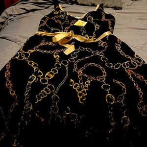 Black sheer dress with gold chain design size large. NWT
